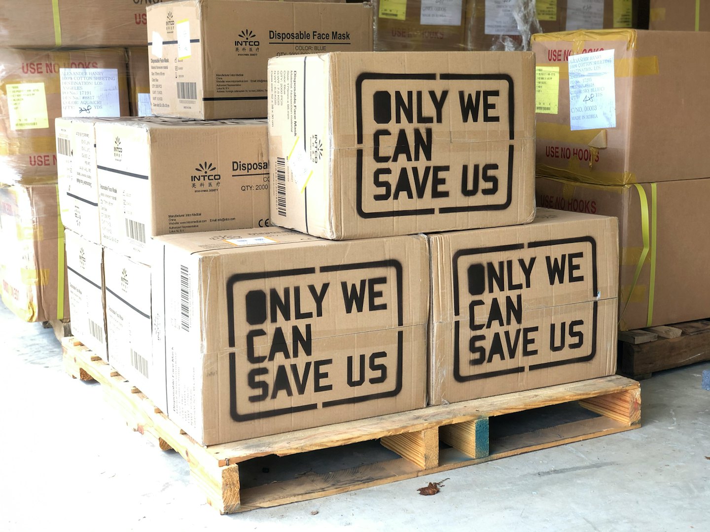 Cardboard shipping boxes on a pallet in a warehouse.