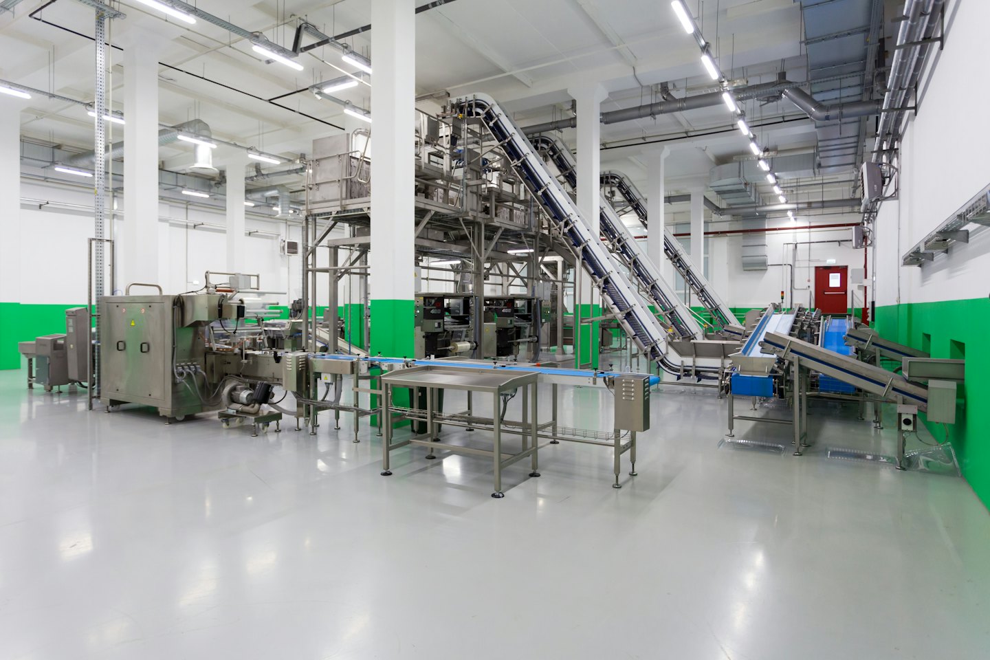 Automated factory machinery on a clean, sterile production line.